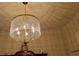 Close-up of a dazzling chandelier with decorative details and ambient lighting at 2562 Pendergrass Ct, Ellenwood, GA 30294