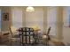 Bright dining area features a round wooden table and four chairs near large windows at 2562 Pendergrass Ct, Ellenwood, GA 30294