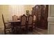 Spacious dining room featuring a wooden table, cabinet, and large shuttered window at 2562 Pendergrass Ct, Ellenwood, GA 30294