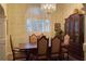 Elegant dining room with a chandelier, shuttered window, and traditional wooden furniture at 2562 Pendergrass Ct, Ellenwood, GA 30294
