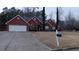 Red brick home with manicured lawn and landscaping, driveway, and mailbox at 2562 Pendergrass Ct, Ellenwood, GA 30294