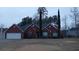 Brick home with a green lawn, featuring a two-car garage and elegant landscaping at 2562 Pendergrass Ct, Ellenwood, GA 30294