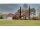 Charming brick home featuring a manicured lawn and two-car garage at 2562 Pendergrass Ct, Ellenwood, GA 30294