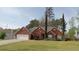 All brick home featuring a manicured lawn, complemented by a two-car garage and detailed trim at 2562 Pendergrass Ct, Ellenwood, GA 30294