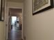 Inviting hallway with wood floors, neutral walls, and well-lit entryway at 2562 Pendergrass Ct, Ellenwood, GA 30294