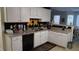 Kitchen featuring granite countertops, white cabinets, and an eye-catching backsplash design at 2562 Pendergrass Ct, Ellenwood, GA 30294