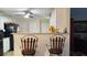 Kitchen view features white cabinets, granite countertops, and bar stool seating at 2562 Pendergrass Ct, Ellenwood, GA 30294