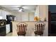 Kitchen view features white cabinets, granite countertops, and bar stool seating at 2562 Pendergrass Ct, Ellenwood, GA 30294