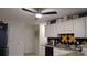 Well-lit kitchen with white cabinets, granite countertops and a ceiling fan at 2562 Pendergrass Ct, Ellenwood, GA 30294