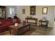 Cozy living room featuring a red sofa, decorative tables, and elegant wall art at 2562 Pendergrass Ct, Ellenwood, GA 30294