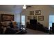 Spacious living room with high ceilings, a ceiling fan, a large art piece, and multiple windows at 2562 Pendergrass Ct, Ellenwood, GA 30294