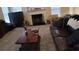 Open living space featuring a fireplace, cozy seating, and large windows for natural light at 2562 Pendergrass Ct, Ellenwood, GA 30294