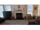 Bright living area with a fireplace, comfortable seating, and multiple windows providing ample light at 2562 Pendergrass Ct, Ellenwood, GA 30294