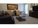 Cozy living room with yellow arm chairs, a large painting, and plush gray carpeting at 2562 Pendergrass Ct, Ellenwood, GA 30294