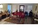 Well-lit living room featuring wood-look floors, shuttered windows, and comfortable furniture at 2562 Pendergrass Ct, Ellenwood, GA 30294