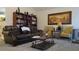 Comfortable living area featuring a brown sofa, a well-stocked bookshelf, and natural light at 2562 Pendergrass Ct, Ellenwood, GA 30294