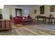 Bright living room showcasing wood-look floors, neutral walls, and shuttered windows at 2562 Pendergrass Ct, Ellenwood, GA 30294