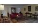 Spacious living room features wood-look flooring, shuttered windows, and stylish accents at 2562 Pendergrass Ct, Ellenwood, GA 30294