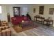 Bright living room featuring wood-look floors, shuttered windows, and stylish decor at 2562 Pendergrass Ct, Ellenwood, GA 30294