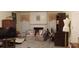 Comfortable living room with decorative fireplace, lots of natural light, and display case at 2562 Pendergrass Ct, Ellenwood, GA 30294