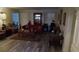 Comfortable living room with wood-look floors, and shutters for natural light control at 2562 Pendergrass Ct, Ellenwood, GA 30294