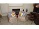 Living room showcasing fireplace, plush chairs, and lots of natural light from bright windows at 2562 Pendergrass Ct, Ellenwood, GA 30294
