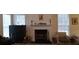 Bright living room with a white fireplace, large windows, and a neutral color palette at 2562 Pendergrass Ct, Ellenwood, GA 30294