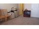 Bright room featuring a printer, bookcase with a collection of books, and neutral-toned carpet at 2562 Pendergrass Ct, Ellenwood, GA 30294