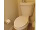 A standard white toilet is positioned with a roll of toilet paper next to it at 2562 Pendergrass Ct, Ellenwood, GA 30294