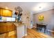 Kitchen with wooden cabinets, stainless steel sink, and adjacent dining area with hardwood floors at 2232 Dunseath Ave # 407, Atlanta, GA 30318