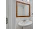 Bathroom with a pedestal sink, decorative mirror, and modern fixtures at 6940 Roswell Rd # E12, Atlanta, GA 30328