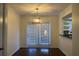 Bright dining area with modern light fixture and sliding glass door to the outside at 6940 Roswell Rd # E12, Atlanta, GA 30328