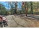 Community dog park with benches, foliage, and shade trees at 6940 Roswell Rd # E12, Atlanta, GA 30328