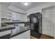 Bright kitchen with granite countertops, white cabinetry, and stainless steel appliances, creating a modern look at 6940 Roswell Rd # E12, Atlanta, GA 30328