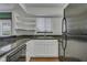 Updated kitchen boasts granite countertops, stainless steel appliances, and ample storage space at 6940 Roswell Rd # E12, Atlanta, GA 30328