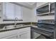 Well-equipped kitchen with stainless steel appliances, granite countertops, and ample natural light from the window at 6940 Roswell Rd # E12, Atlanta, GA 30328