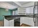 Open kitchen with granite countertops, white cabinets, stainless appliances, and a view to dining at 6940 Roswell Rd # E12, Atlanta, GA 30328