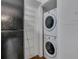 Convenient in-unit laundry with stacked washer and dryer, and extra storage shelving at 6940 Roswell Rd # E12, Atlanta, GA 30328