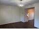 Spacious living room area with hardwood flooring and a modern chandelier light fixture at 6940 Roswell Rd # E12, Atlanta, GA 30328
