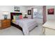 Bright bedroom featuring a large window, colorful bedding, and classic wooden furniture at 75 Fair Haven Se Way, Smyrna, GA 30080