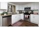 Modern kitchen with white cabinets, granite counters, and stainless steel appliances at 75 Fair Haven Se Way, Smyrna, GA 30080