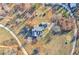 Aerial view of the property showcasing the home, surrounding landscape, and long drive with mature trees and landscaping at 3975 Mcconnell Rd, Cumming, GA 30028