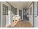 Inviting back porch featuring wooden floors, white railings, lots of light, and outdoor seating at 3975 Mcconnell Rd, Cumming, GA 30028