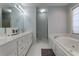 Bright bathroom features double vanity, large mirror, and separate tub and shower at 3975 Mcconnell Rd, Cumming, GA 30028