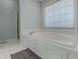 Relaxing bathroom features a large soaking tub, separate shower, and white tile floors at 3975 Mcconnell Rd, Cumming, GA 30028