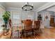 Dining room with hardwood floors, a table with 6 chairs, and a chandelier at 3975 Mcconnell Rd, Cumming, GA 30028
