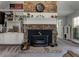 Living room with a stone fireplace, built-in shelving, and neutral carpet at 3975 Mcconnell Rd, Cumming, GA 30028