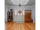 Foyer with a white front door, chandelier, and hardwood floors at 3975 Mcconnell Rd, Cumming, GA 30028