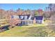 Charming home with a welcoming front porch, manicured lawn, and mature trees creating a serene setting at 3975 Mcconnell Rd, Cumming, GA 30028