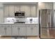 Contemporary kitchen with light gray cabinets, quartz countertops, and stainless steel refrigerator at 3975 Mcconnell Rd, Cumming, GA 30028